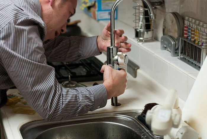Close-up of a blue industrial water valve and metal piping system